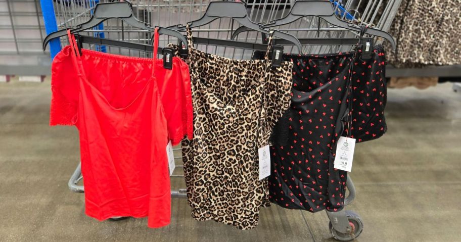 three Joyspun Women&rsquo;s Lace Trim Satin Cami & Shorts Sets hanging on cart in store