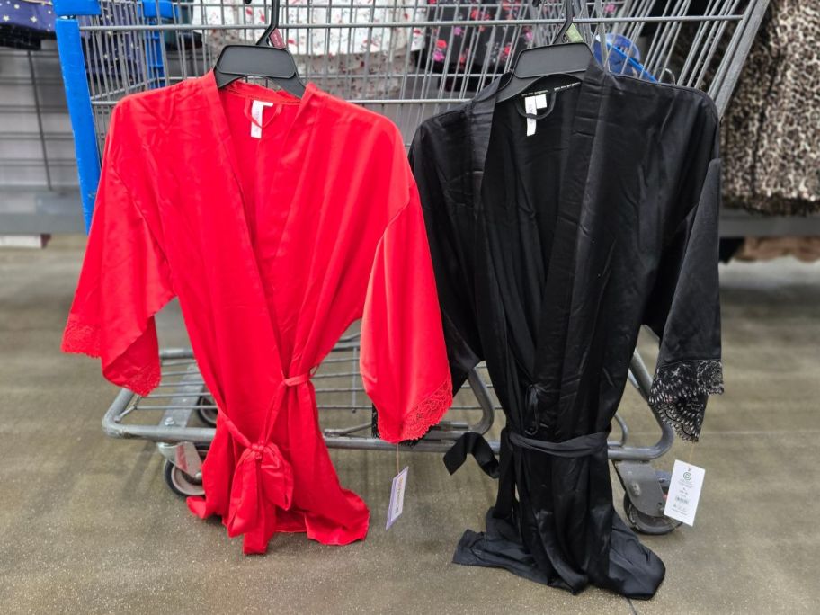 two Joyspun Women&rsquo;s Lace Trim Satin Robes hanging on cart in store