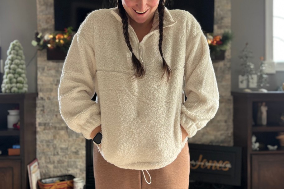 woman in white pullover with hands in pockets