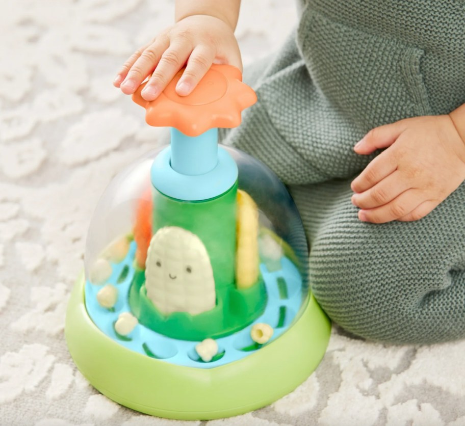 baby's hand on push toy
