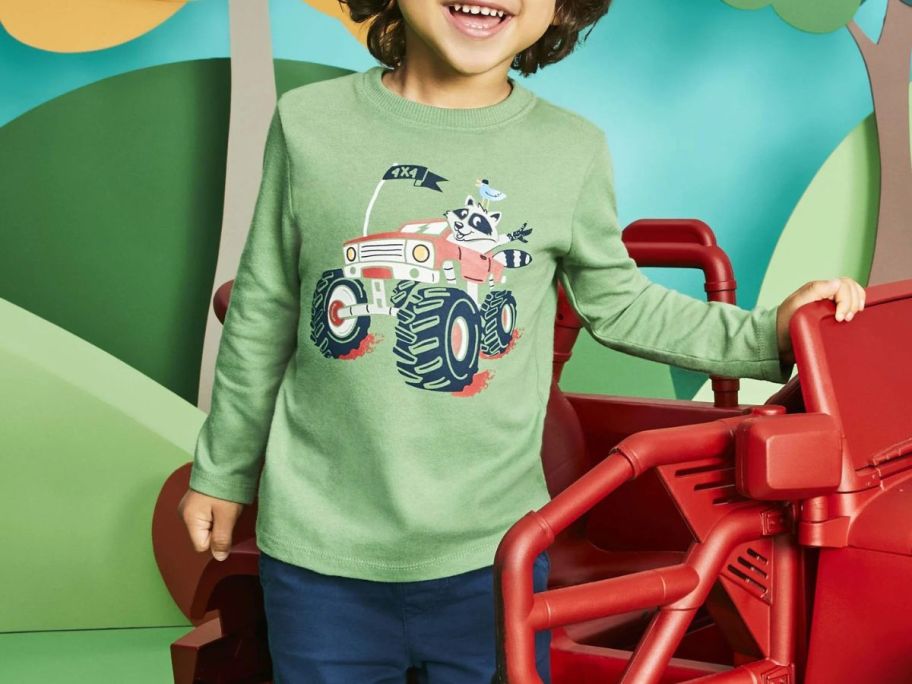 kid wearing shirt with truck on it
