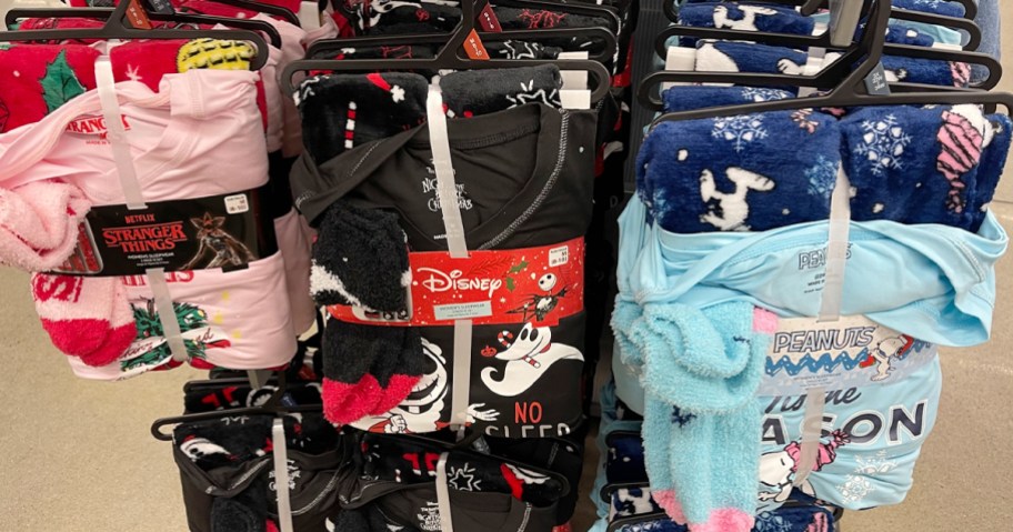 stranger things, nightmare before christmas, and peanuts pajamas hanging in store