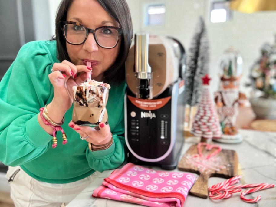woman drinking a peppermint mocha frappe from a ninja slushie
