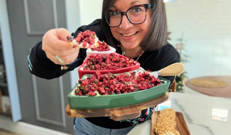 woman holding a christmas tray with cranberry jalapeno dip