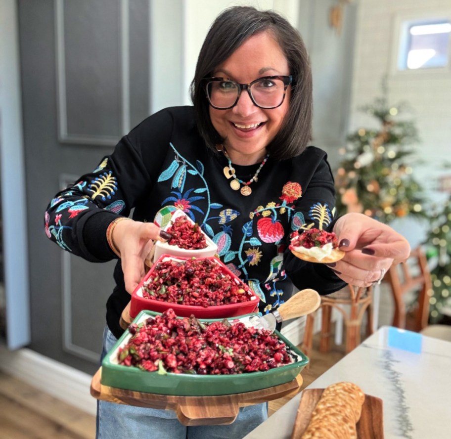 woman holding a cranberry jalapeno dip