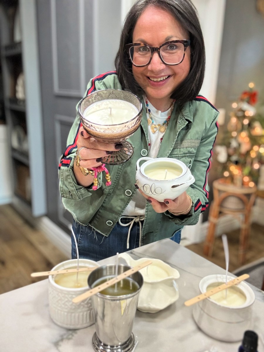 woman holding homemade soy candles repurposing thrift store china