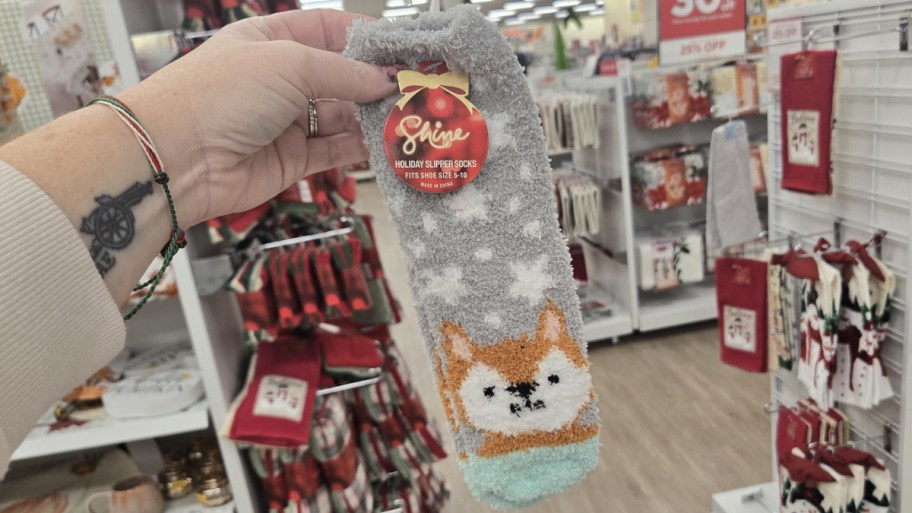womans hand holding a pair of cozy socks