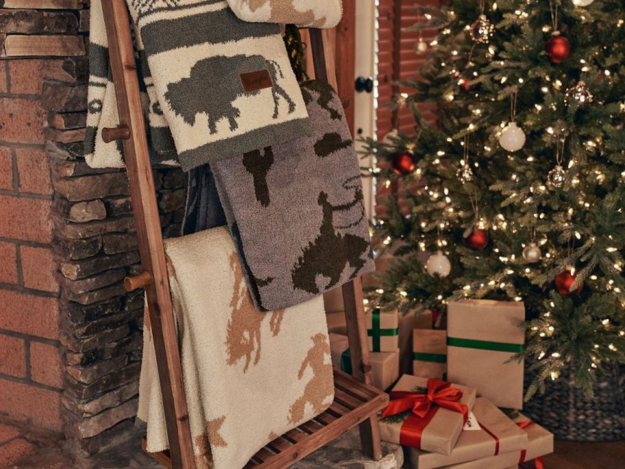 blankets hanging on ladder near christmas tree