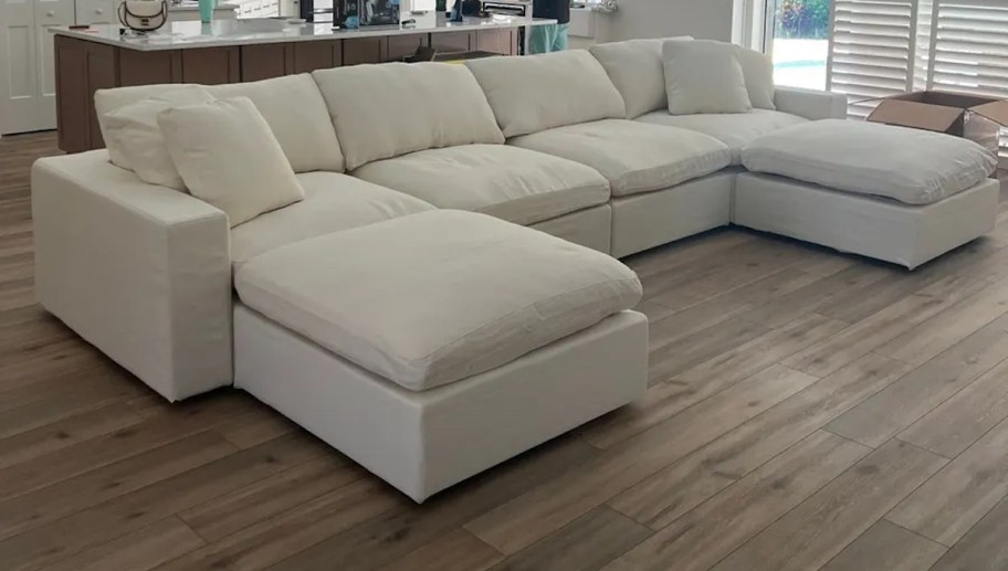 white sectional sofa on wood floor in home