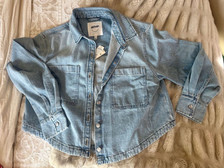 An Aerie Buttowndown Denim shirt on a bed