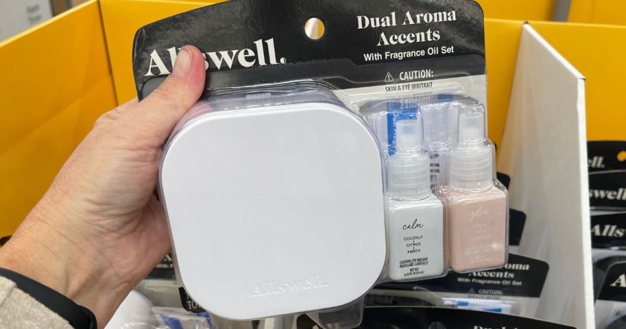 Hand holding an Allswell Dual Diffuser with two refills