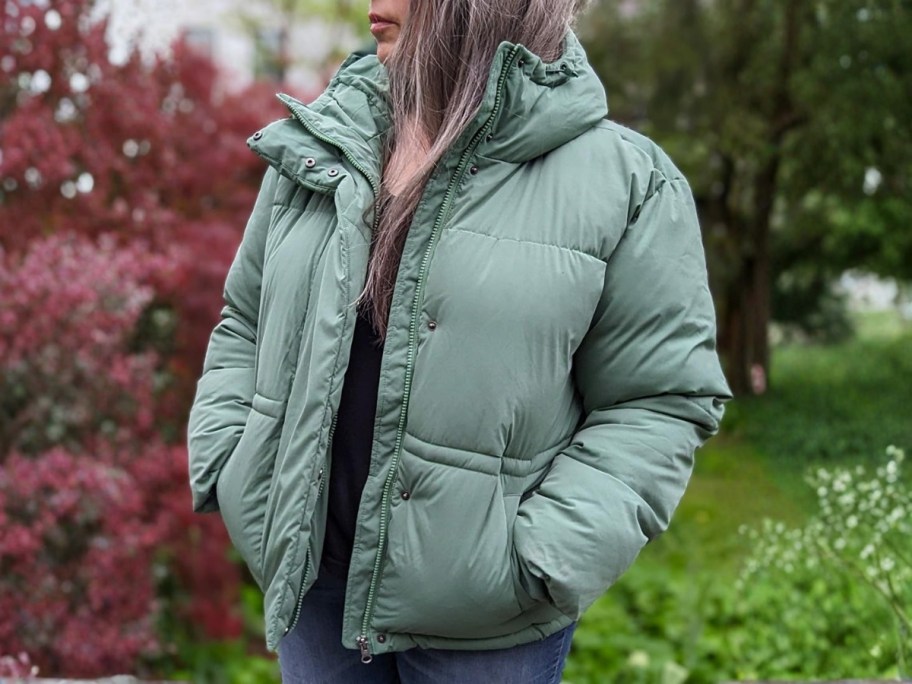 woman wearing green amazon essentials puffer coat outside