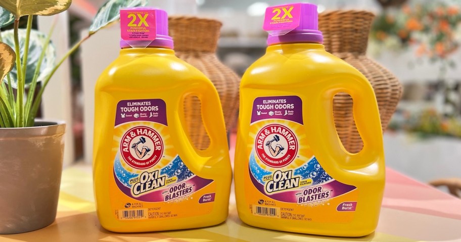 two large yellow bottles of Arm & Hammer Laundry Detergent on a table
