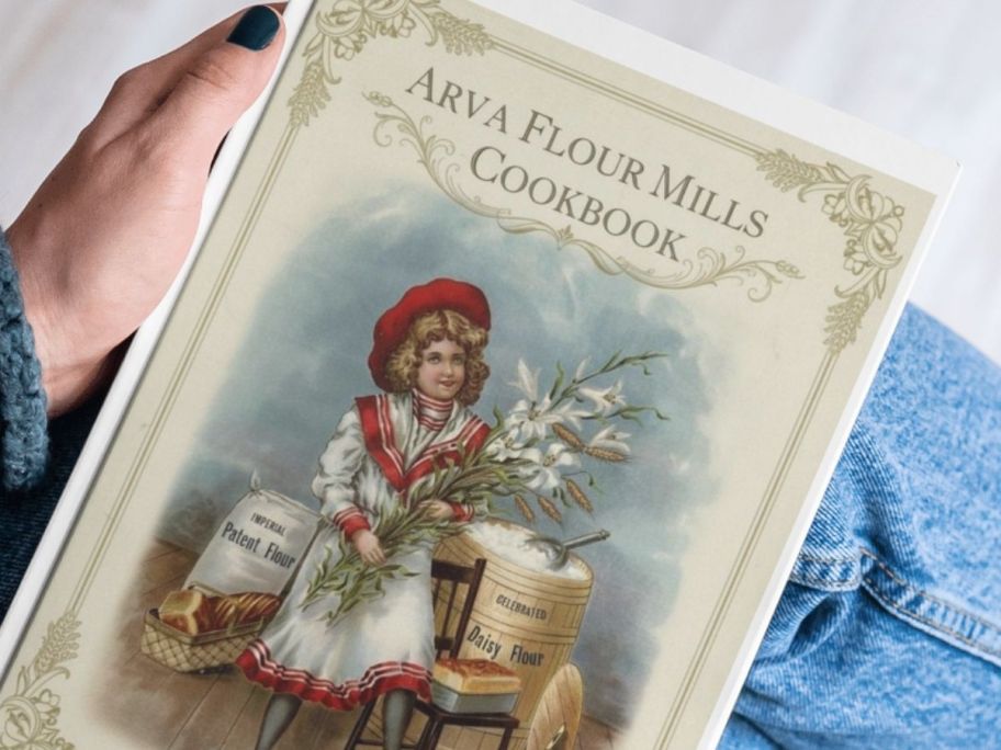 A person holding a cookbook