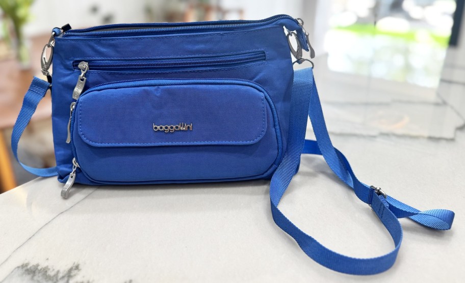 blue crossbody bag on a counter