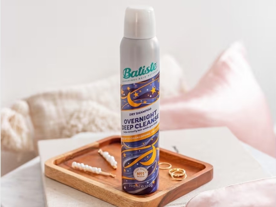 bottle of batiste overnight deep cleanse dry shampoo on wood tray