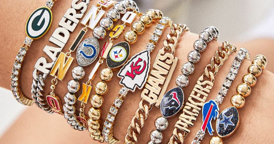 Wrist with lots of Baublebar NFL bracelets