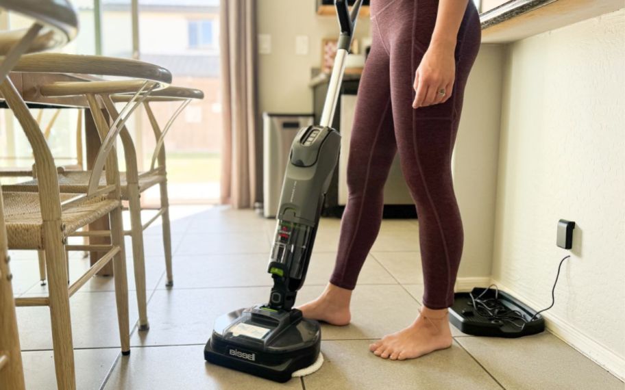 woman using her bissell vacuum mop on her floors