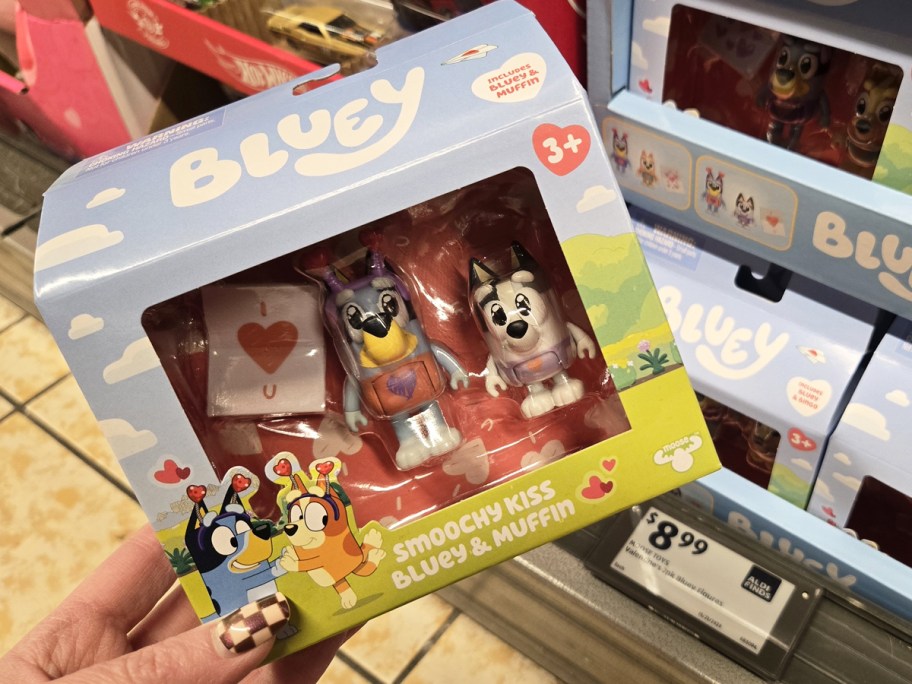 hand holding boxed Bluey Smoochy Kiss Bluey & Muffin Toy in store