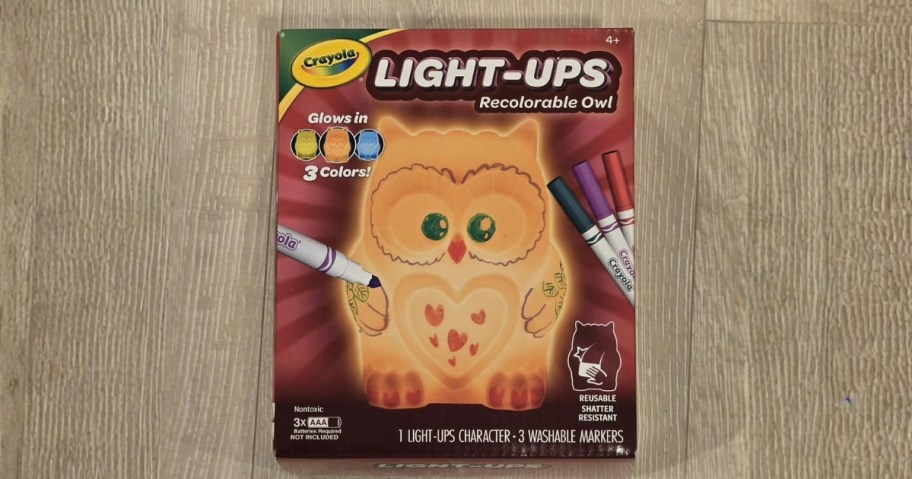 box with crayola light-ups owl sitting on wood floor