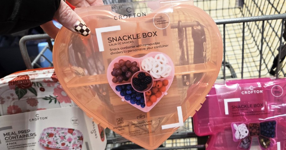 hand holding up a pink heart-shaped Snackle Box