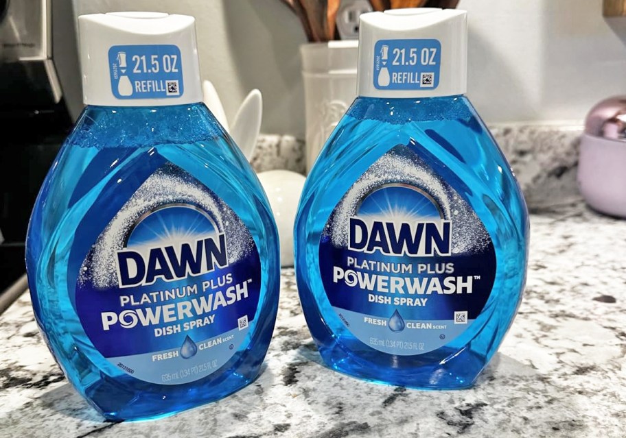 two blue bottles of Dawn Powerwash refills on kitchen counter