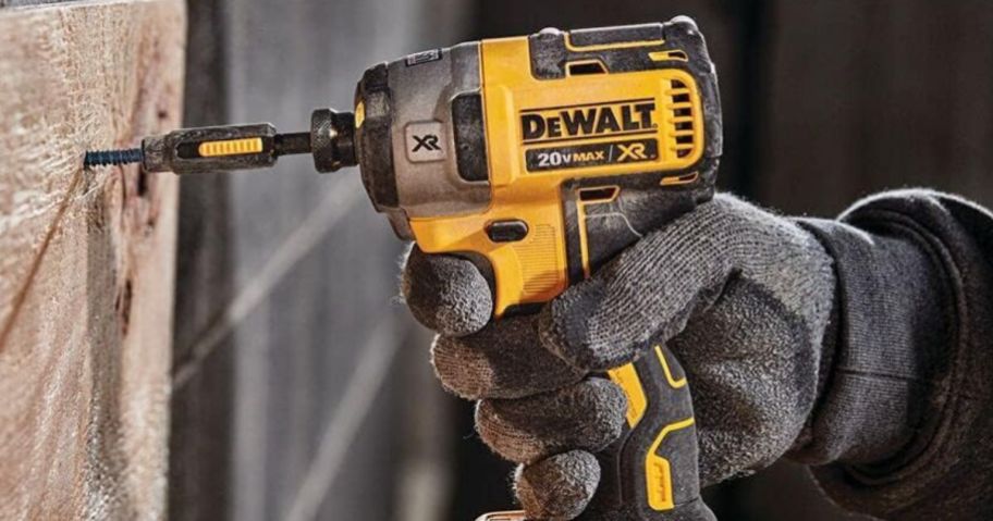 Hand using a DeWalt Impact Wrench
