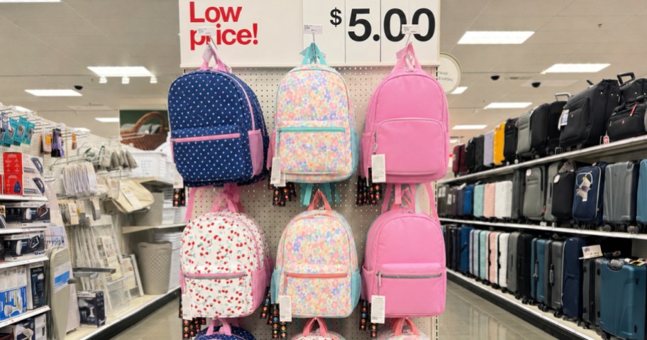 Different colored backpacks hanging on rack inside target store