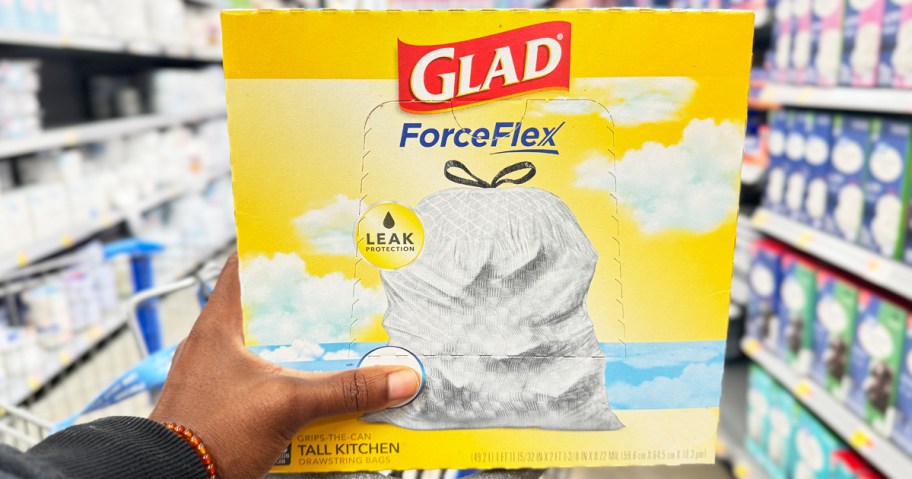 hand holding a yellow box of Glad ForceFlex Trash Bags in store