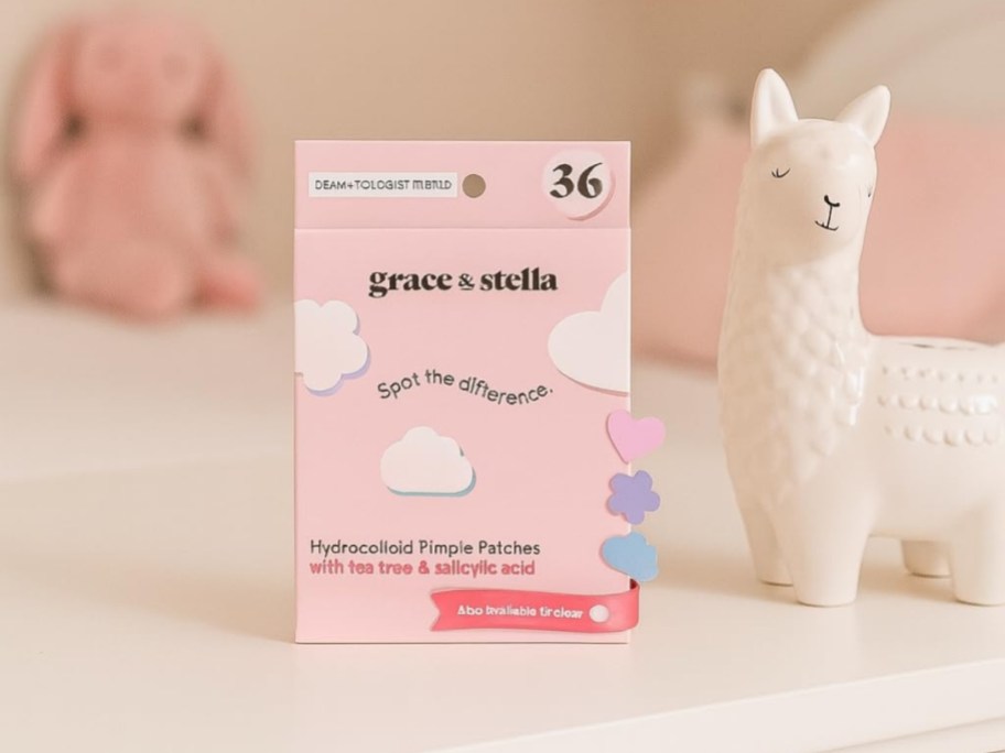 box of grace & stella pimple patches on table with llama figurine