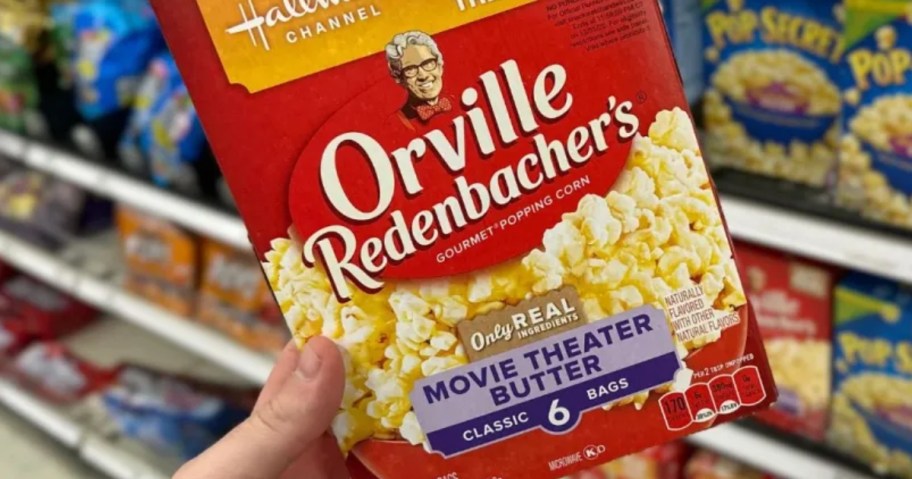 hand holding a box of Orville Redenbacher's Movie Theater Butter Microwave Popcorn