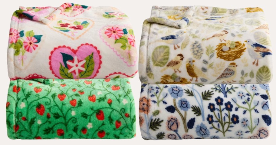 four patterned blankets folded and stacked