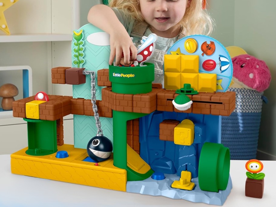 little girl playing with a Super Mario toy playset