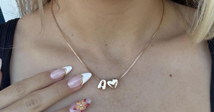 Woman wearing a heart initial necklace
