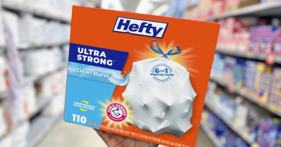 hand holding up a large box of Hefty trash bags in store