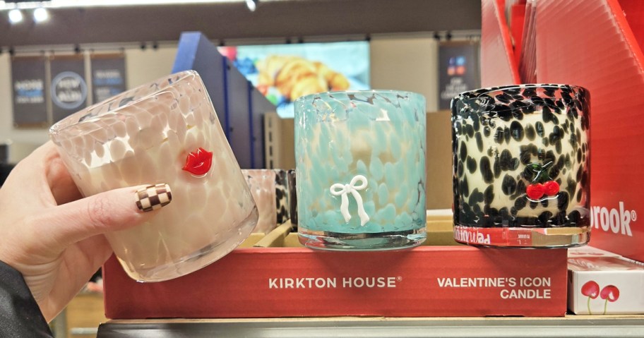 hand grabbing a jar candle from store display