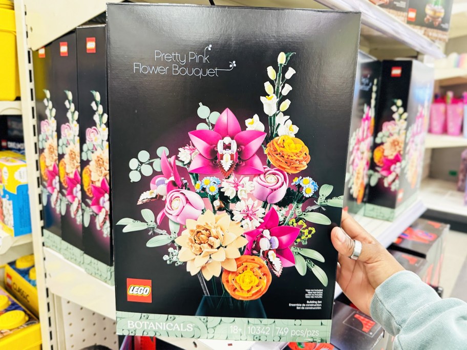 hand holding up LEGO Botanicals Pretty Pink Flower Bouquet box in store