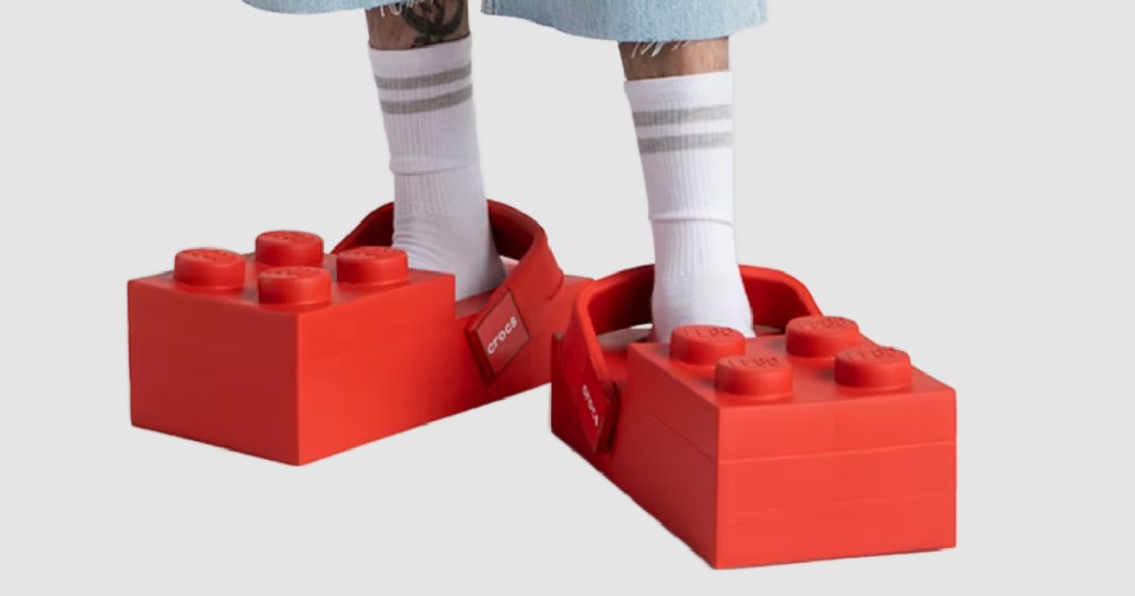 Man wearing pair of large red Lego crocs