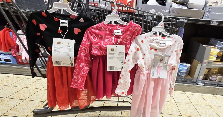 girls valentines day dresses hanging off a shopping cart