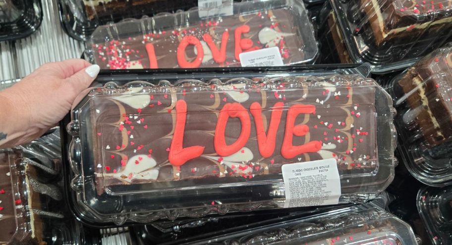Tuxedo cake of love holding hands in the store