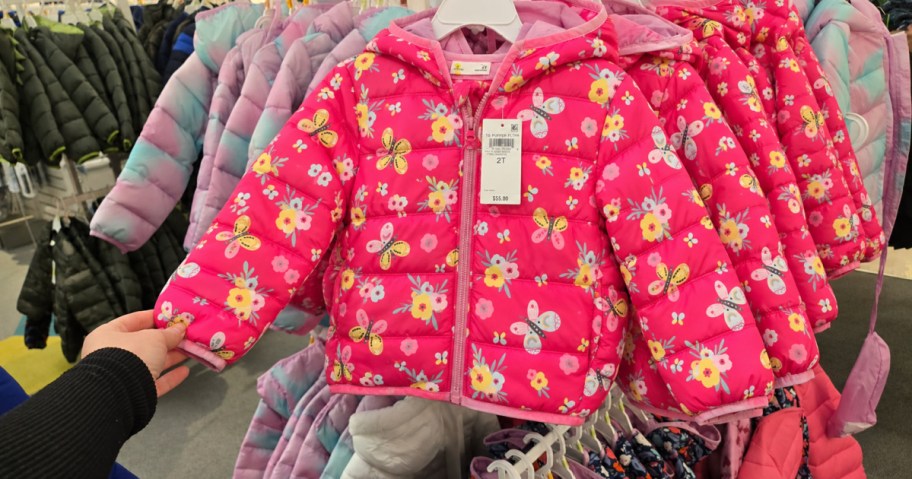 Pink butterfly kids puffer jackets on display inside Macy's store