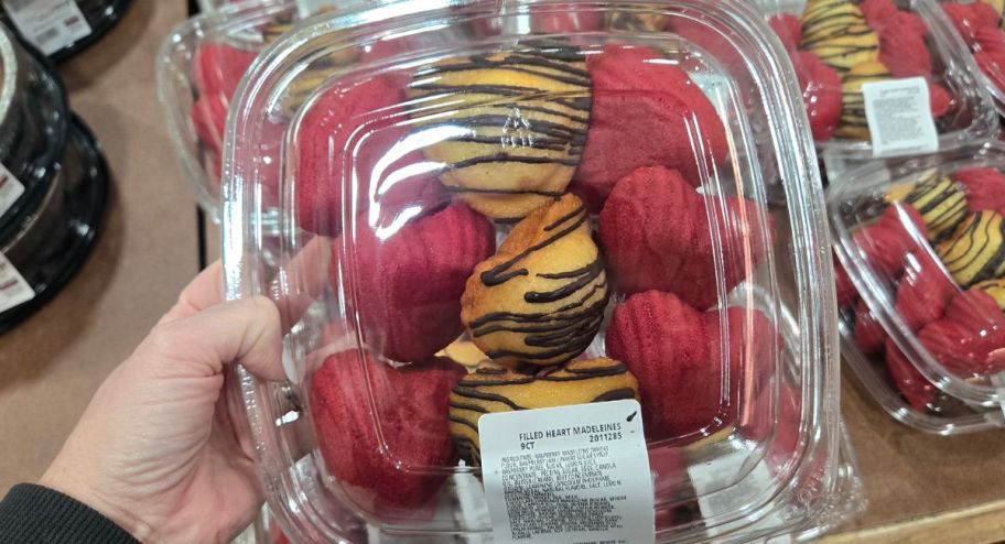 Hand holding madeleines filled with chocolate