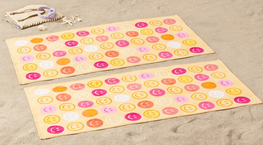 smiley face beach towels on sand