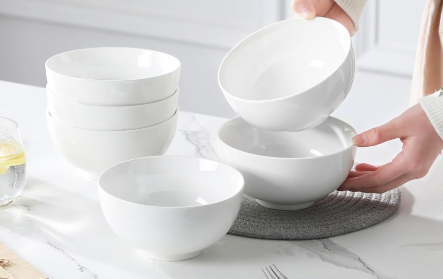 person playing white bowls on a table