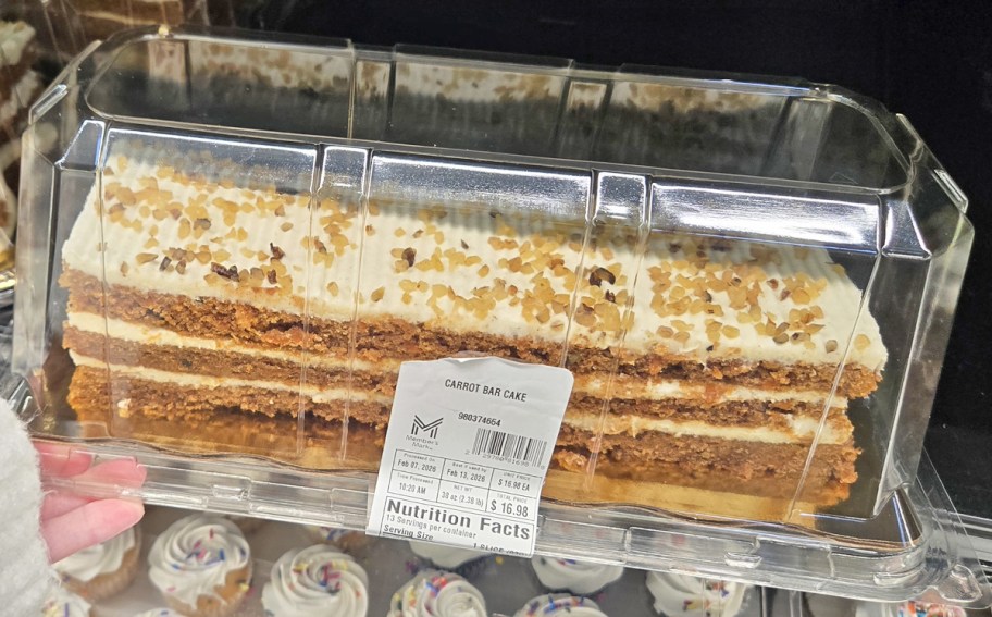 hand holding a carrot bar cake in store