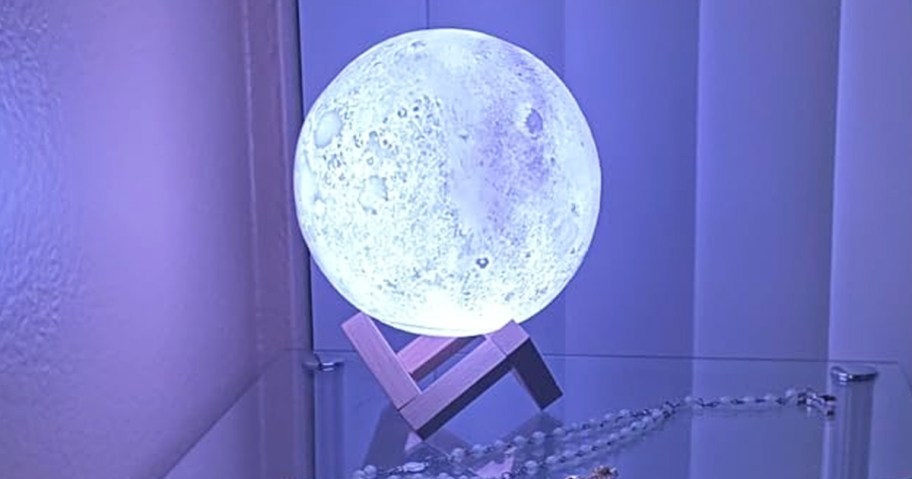 round moon lamp glowing in dark room