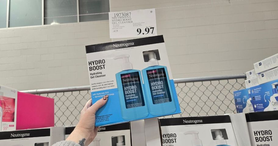 A person holding up a box with Neutrogena products