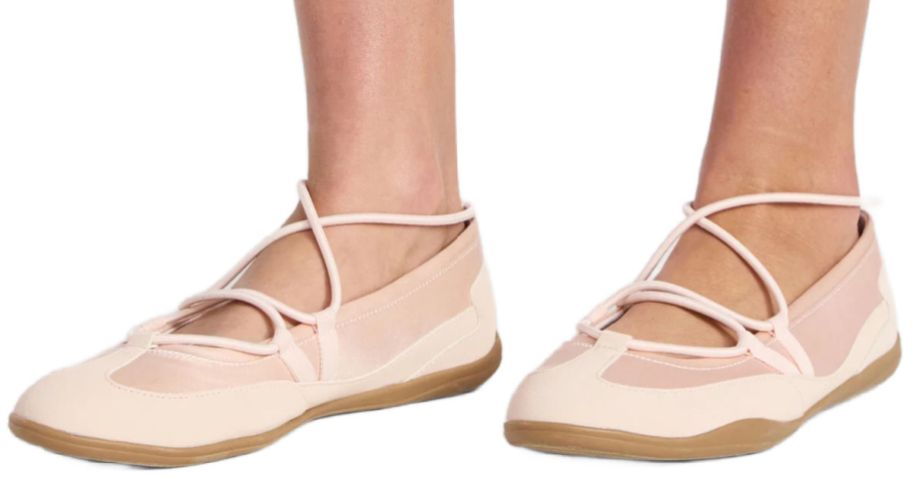 feet wearing pink ballet flats