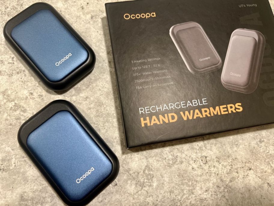 A box with two blue Ocoopa hand warmers