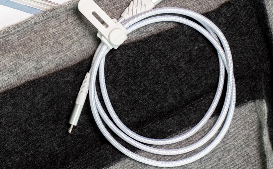 white coiled up charing cable with cable management wrap